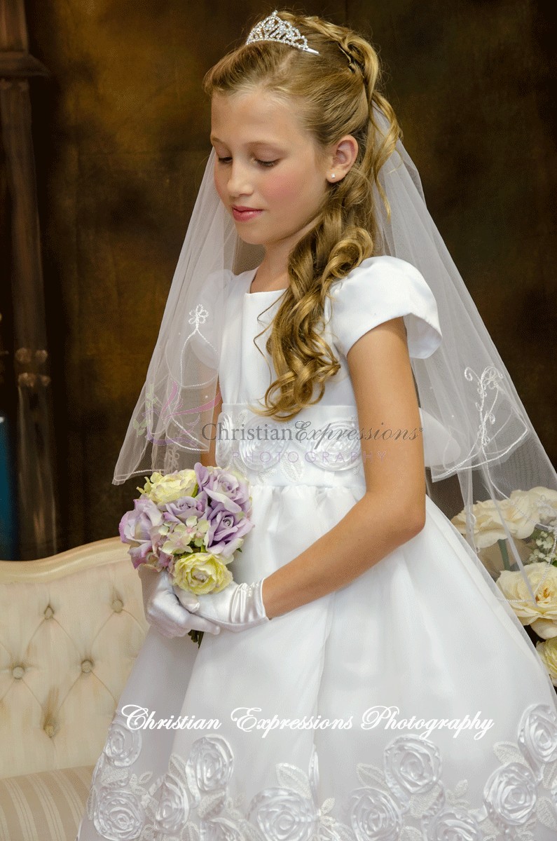 White first communion dresses with large rosettes